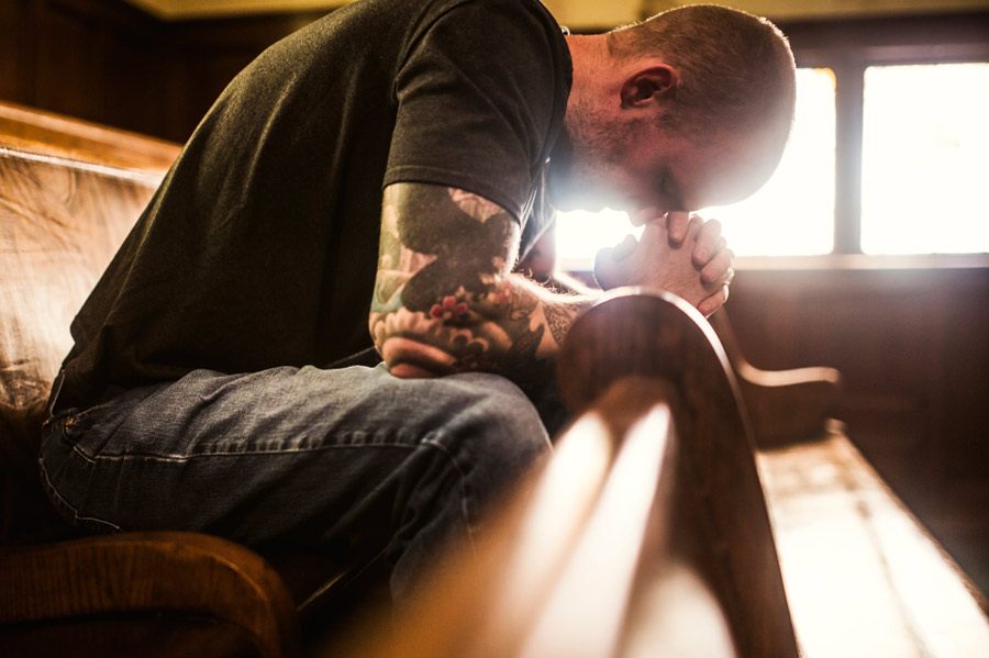 man-praying-in-church