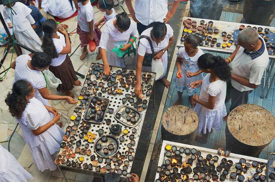 People light candles at the Buddhist temple during Vesak religious celebration in Colombo, Sri Lanka.