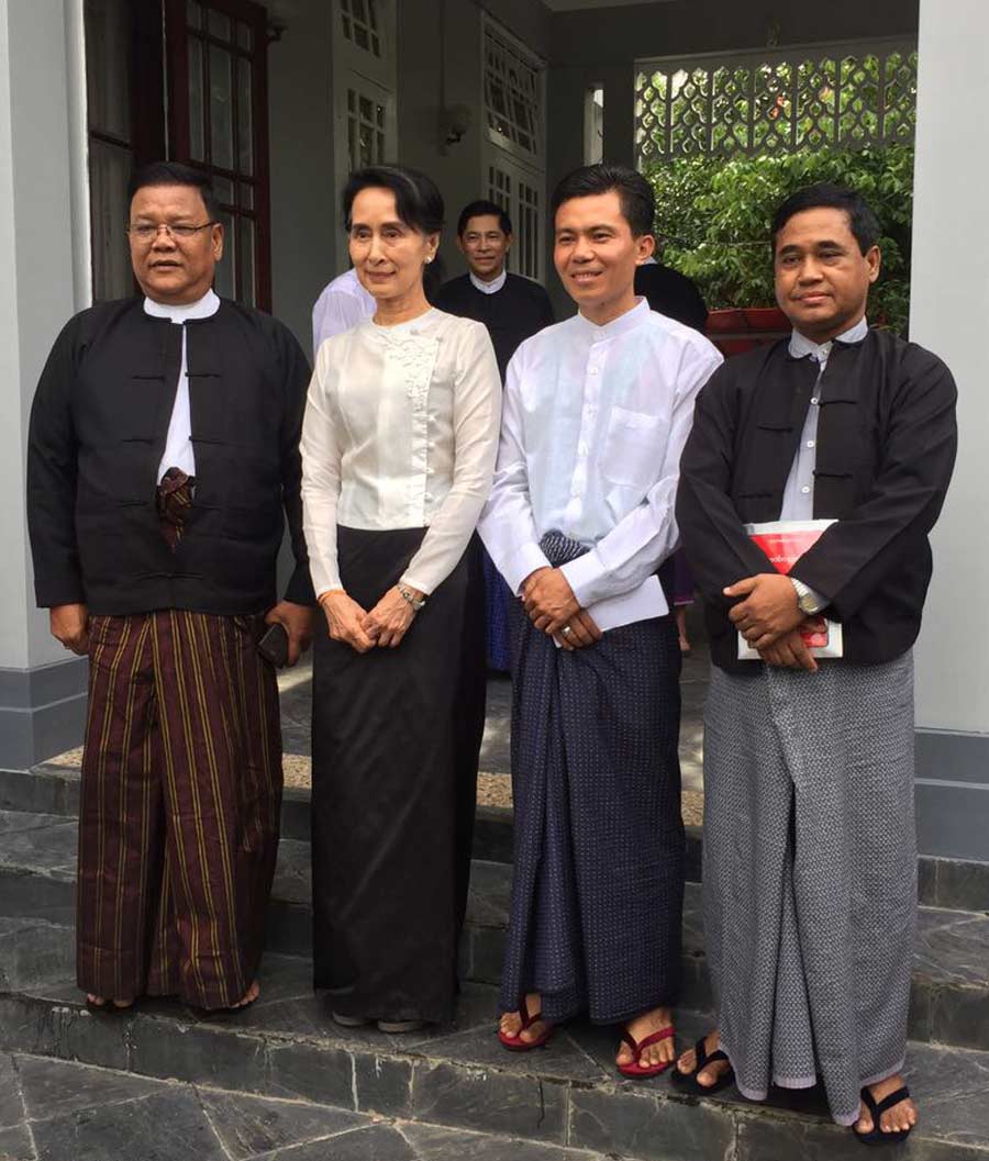 Aung San Suu Kyi (center left) with representatives of the Baha’i community of Myanmar (from left to right: U Shwe Thee, U Myint Zaw Oo, U Tin Win)