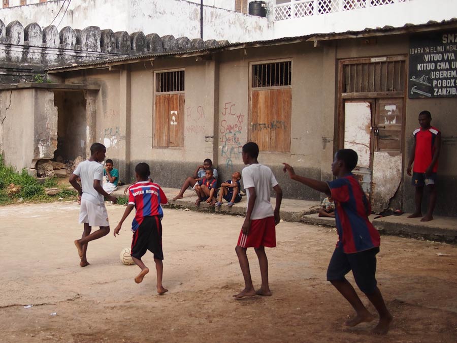 Tanzania-boys-play-soccer-outside-school-bahaiteachings