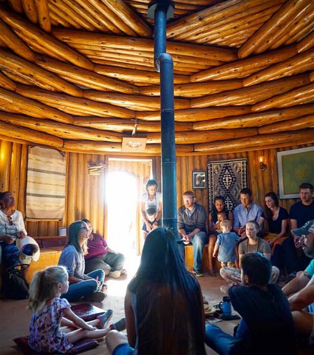 A prayer gathering inside the Prayer Hogan at the Native American Baha’i Institute in the Navajo Nation.