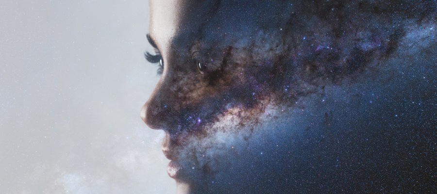 a mystical image of a woman’s face encompassing the universe